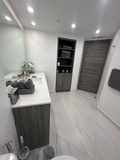19500 Turnberry Way Unit 12A, Aventura, FL 33180 - bathroom featuring vanity, built in features, marble finish floors, and recessed lighting