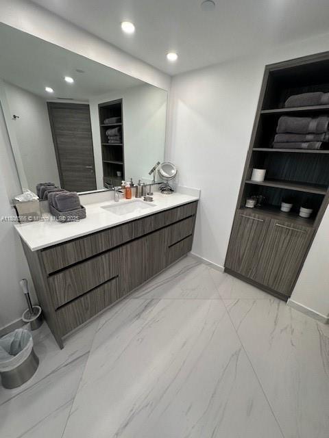 19500 Turnberry Way Unit 12A, Aventura, FL 33180 - bathroom featuring marble look tiles, vanity, recessed lighting, and baseboards