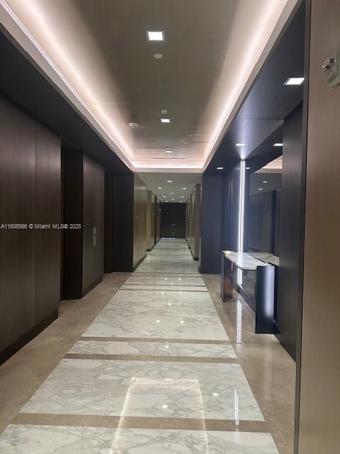 19500 Turnberry Way Unit 12A, Aventura, FL 33180 - corridor with light marble finish flooring and a raised ceiling