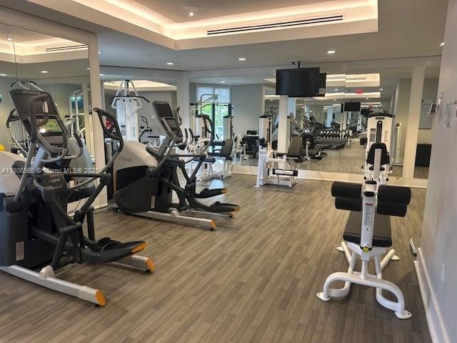 19500 Turnberry Way Unit 12A, Aventura, FL 33180 - workout area featuring a raised ceiling, wood finished floors, and recessed lighting