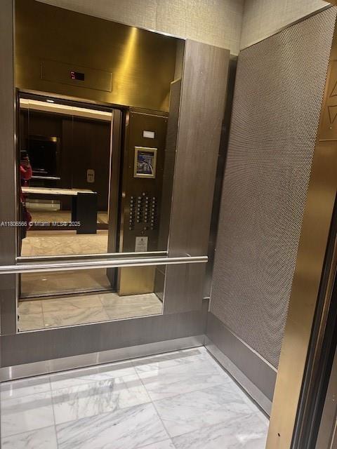 19500 Turnberry Way Unit 12A, Aventura, FL 33180 - bathroom with marble look tiles