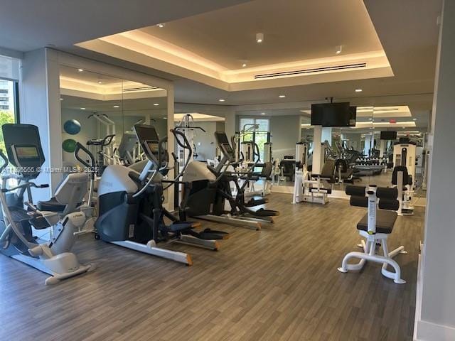 19500 Turnberry Way Unit 12A, Aventura, FL 33180 - workout area with a tray ceiling and wood finished floors
