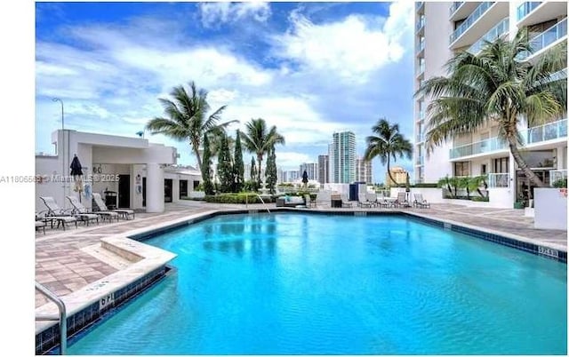 19500 Turnberry Way Unit 12A, Aventura, FL 33180 - community pool featuring a patio area