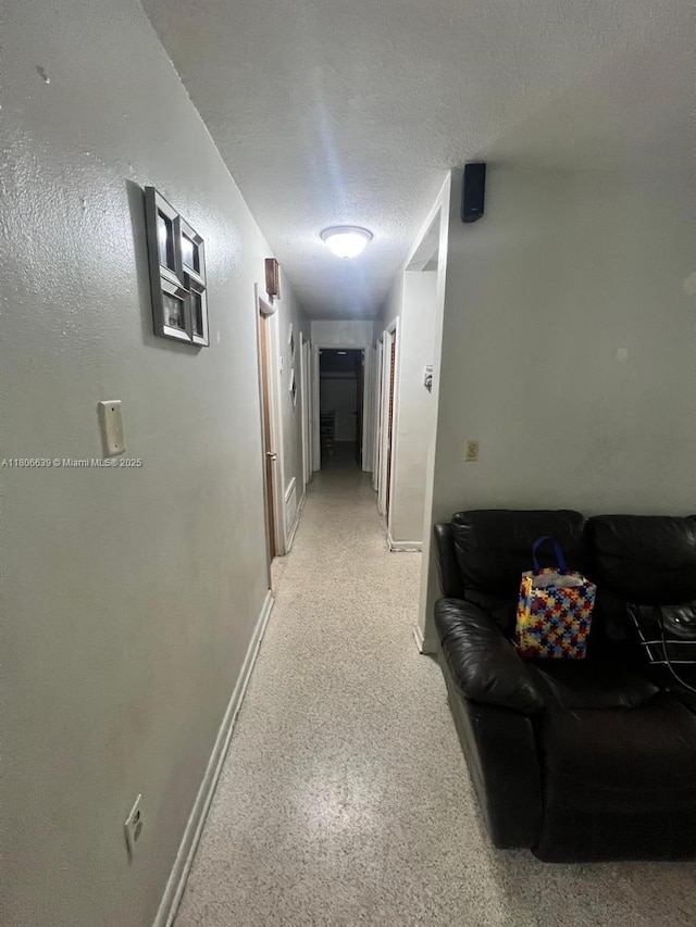 2990 W 7th Ave, Hialeah, FL 33012 - hall with baseboards and a textured ceiling