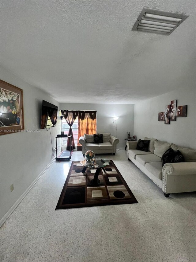 2990 W 7th Ave, Hialeah, FL 33012 - living room with a textured ceiling and baseboards
