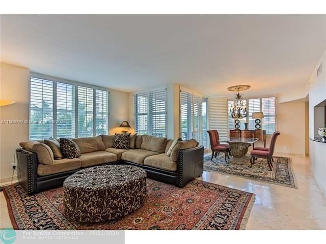 2100 N Ocean Blvd Unit 5B, Fort Lauderdale, FL 33305 - living room with a chandelier, plenty of natural light, and baseboards