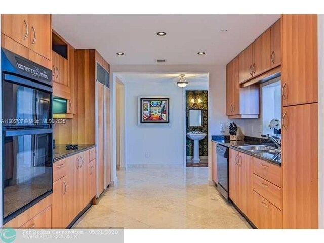2100 N Ocean Blvd Unit 5B, Fort Lauderdale, FL 33305 - kitchen featuring black appliances, a sink, baseboards, and recessed lighting
