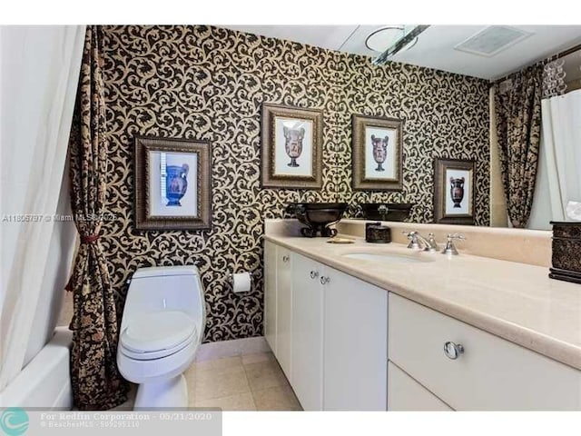 2100 N Ocean Blvd Unit 5B, Fort Lauderdale, FL 33305 - full bath with wallpapered walls, vanity, baseboards, toilet, and tile patterned flooring