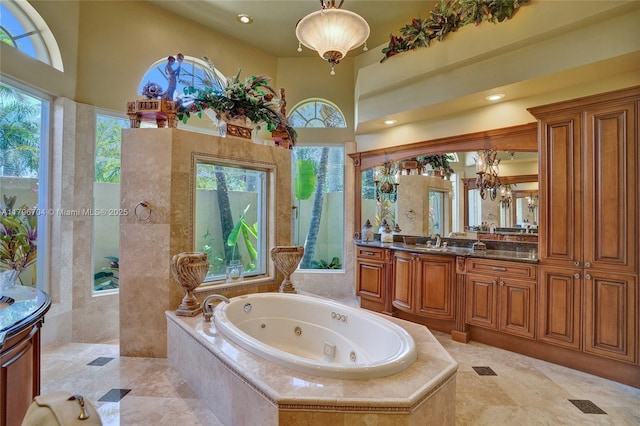 10233 NW 66th Dr, Parkland, FL 33076 - bathroom with vanity, a tub with jets, a walk in shower, and a towering ceiling