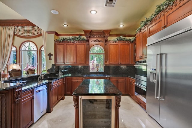 10233 NW 66th Dr, Parkland, FL 33076 - kitchen with stainless steel appliances, a sink, plenty of natural light, dark stone counters, and crown molding
