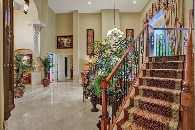 10233 NW 66th Dr, Parkland, FL 33076 - stairs with a chandelier, ornate columns, marble tiled floors, and recessed lighting