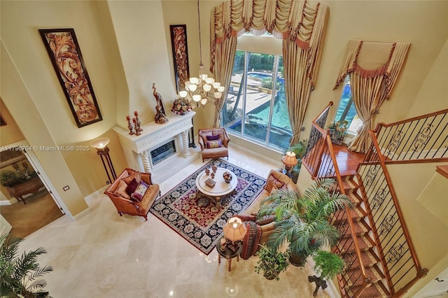 10233 NW 66th Dr, Parkland, FL 33076 - living room with a towering ceiling, a high end fireplace, a chandelier, and stairway