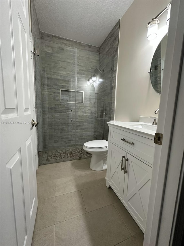 19260 SW 29th Ct, Miramar, FL 33029 - bathroom featuring tile patterned floors, vanity, toilet, a shower stall, and a textured ceiling