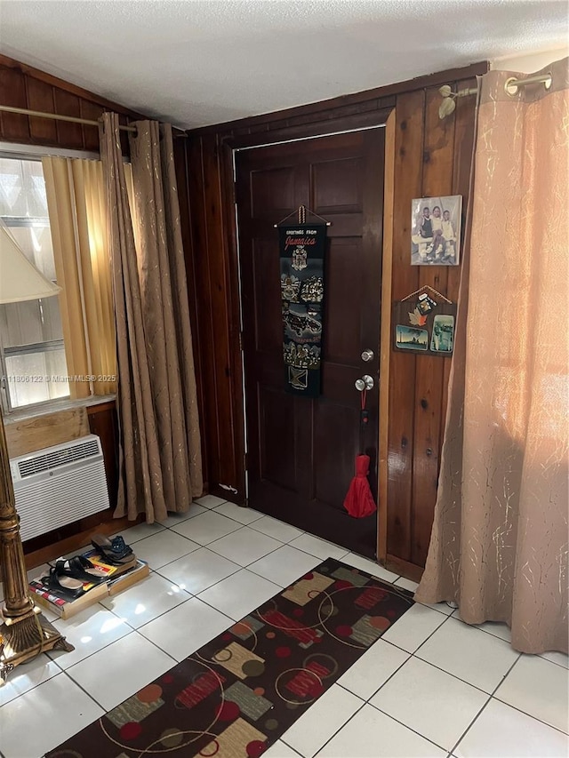 1527 NW 101st St, Miami, FL 33147 - entryway with light tile patterned floors, a wall mounted AC, and wood walls