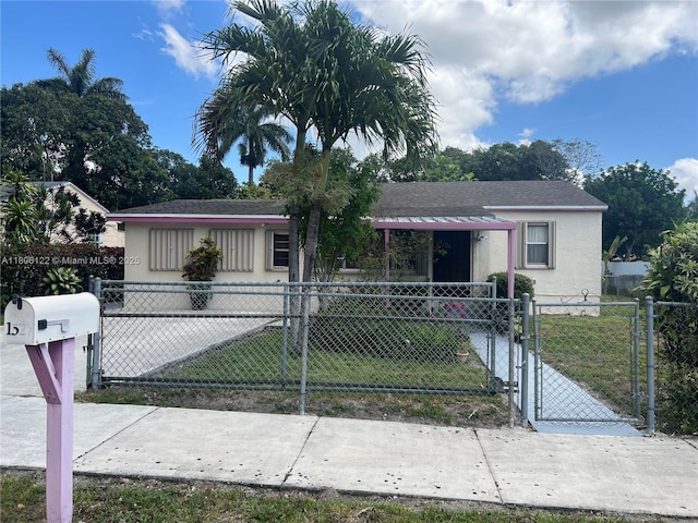 1527 NW 101st St, Miami, FL 33147 - view of front of home with a gate, stucco siding, and roof with shingles