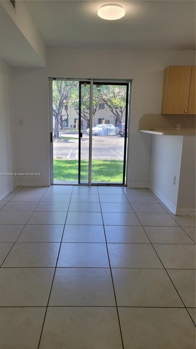 2921 SE 13th Ave Unit 106-48, Homestead, FL 33035 - unfurnished dining area with light tile patterned floors and baseboards
