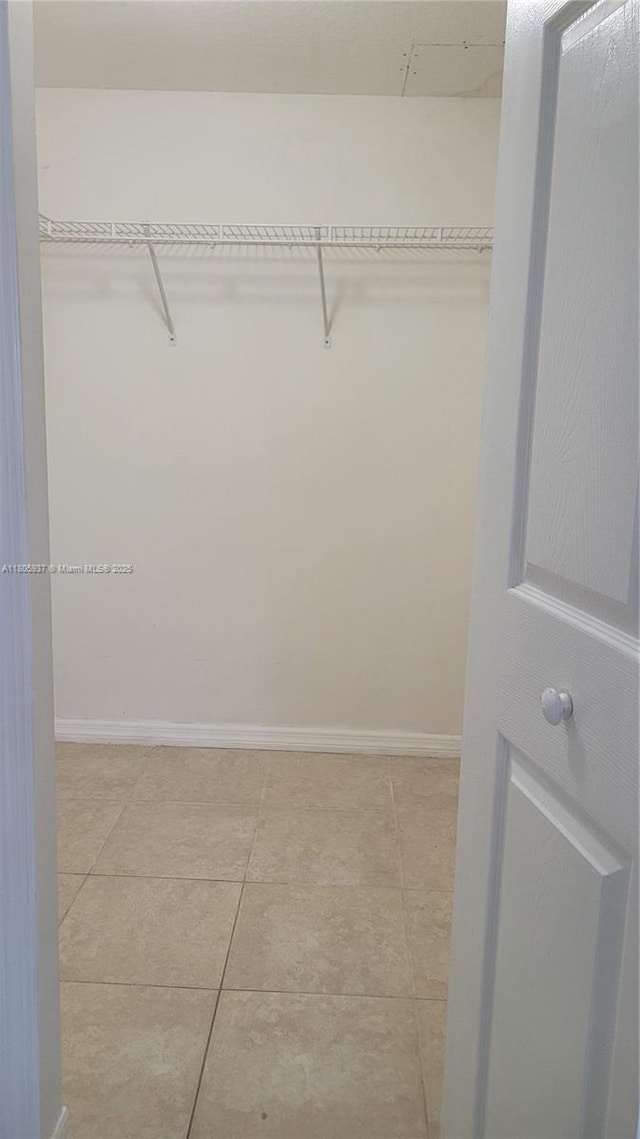 2921 SE 13th Ave Unit 106-48, Homestead, FL 33035 - walk in closet with light tile patterned floors