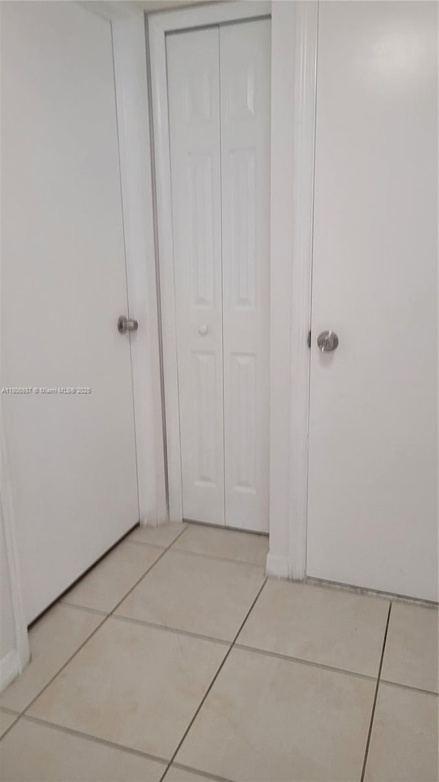 2921 SE 13th Ave Unit 106-48, Homestead, FL 33035 - hallway featuring light tile patterned floors