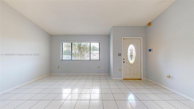 9936 SW 155th St, Miami, FL 33157 - foyer entrance featuring light tile patterned flooring and baseboards