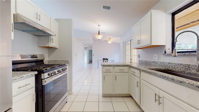 9936 SW 155th St, Miami, FL 33157 - kitchen with gas range, under cabinet range hood, a sink, light tile patterned floors, and white cabinetry