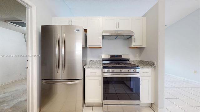 9936 SW 155th St, Miami, FL 33157 - kitchen featuring appliances with stainless steel finishes, under cabinet range hood, light stone countertops, and white cabinetry