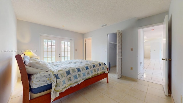 9936 SW 155th St, Miami, FL 33157 - bedroom featuring french doors, access to outside, light tile patterned floors, a textured ceiling, and a spacious closet