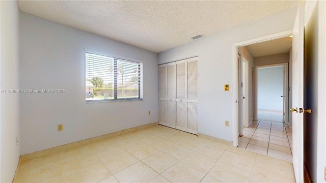 9936 SW 155th St, Miami, FL 33157 - unfurnished bedroom with a closet, light tile patterned floors, and a textured ceiling