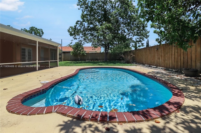 9936 SW 155th St, Miami, FL 33157 - view of swimming pool with a fenced backyard, a patio area, and a sunroom