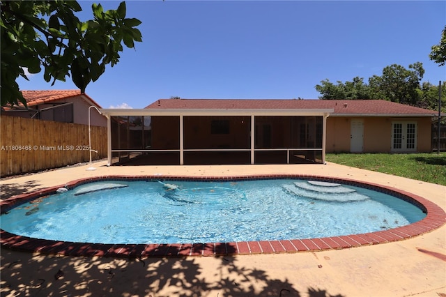 9936 SW 155th St, Miami, FL 33157 - view of swimming pool with a sunroom, french doors, and a patio area