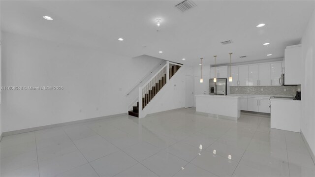 2621 NE 212th Ter Unit 209, Miami, FL 33180 - unfurnished living room featuring stairway, recessed lighting, baseboards, and light tile patterned flooring