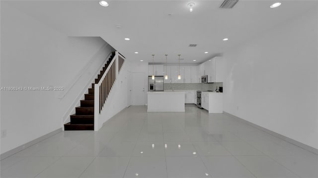 2621 NE 212th Ter Unit 209, Miami, FL 33180 - unfurnished living room featuring stairs, recessed lighting, light tile patterned flooring, and baseboards