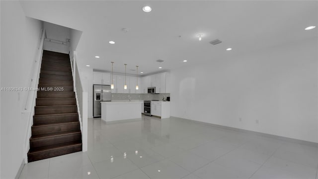 2621 NE 212th Ter Unit 209, Miami, FL 33180 - unfurnished living room featuring recessed lighting, stairs, light tile patterned floors, and baseboards