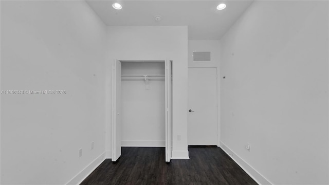 2621 NE 212th Ter Unit 209, Miami, FL 33180 - unfurnished bedroom featuring baseboards, dark wood-style floors, recessed lighting, and a closet