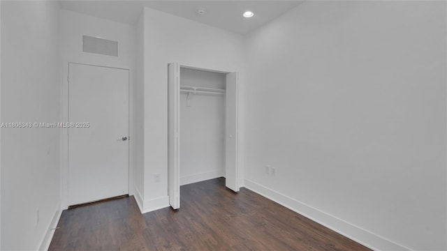 2621 NE 212th Ter Unit 209, Miami, FL 33180 - unfurnished bedroom with baseboards, dark wood-style flooring, a closet, and recessed lighting