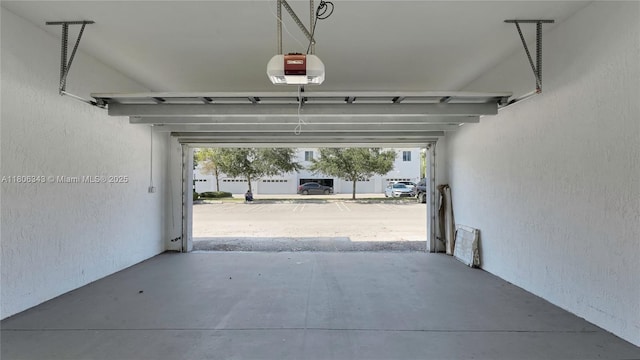 2621 NE 212th Ter Unit 209, Miami, FL 33180 - garage with a garage door opener and a textured wall