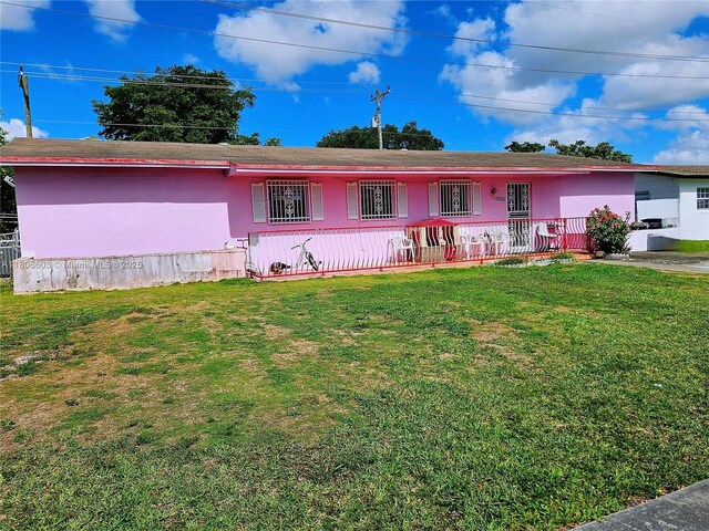15600 SW 106th Ave, Miami, FL 33157 - ranch-style house with a front yard, covered porch, and stucco siding