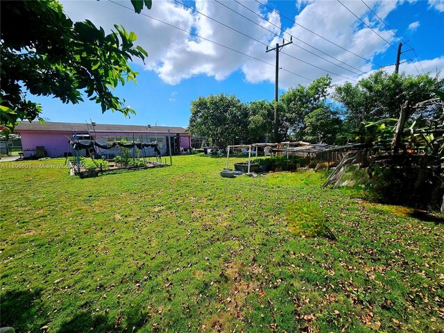 15600 SW 106th Ave, Miami, FL 33157 - view of green lawn featuring a vegetable garden
