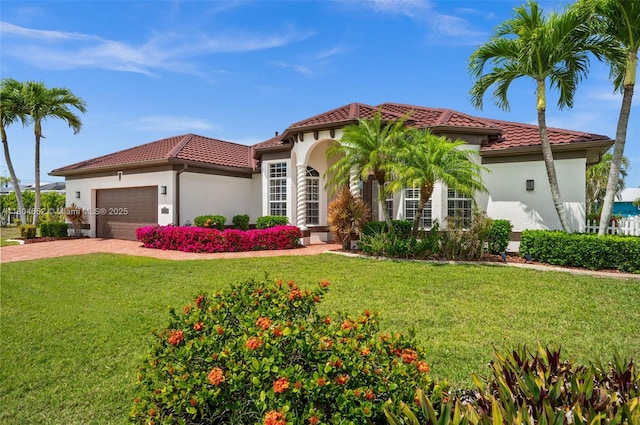249 SW 37th Ln, Cape Coral, FL 33914 - mediterranean / spanish home featuring a tile roof, an attached garage, a front yard, stucco siding, and driveway