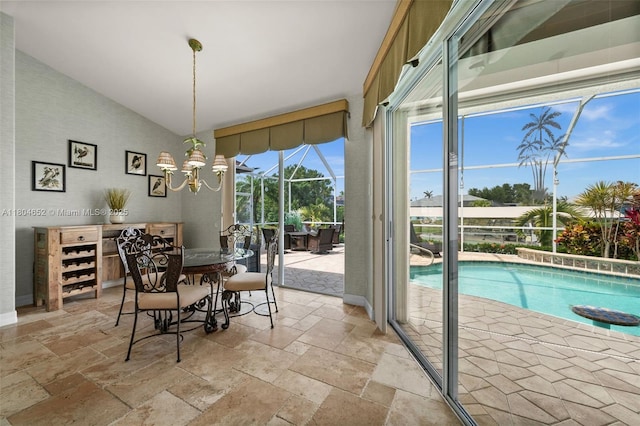 249 SW 37th Ln, Cape Coral, FL 33914 - dining area featuring stone tile flooring, lofted ceiling, and a sunroom