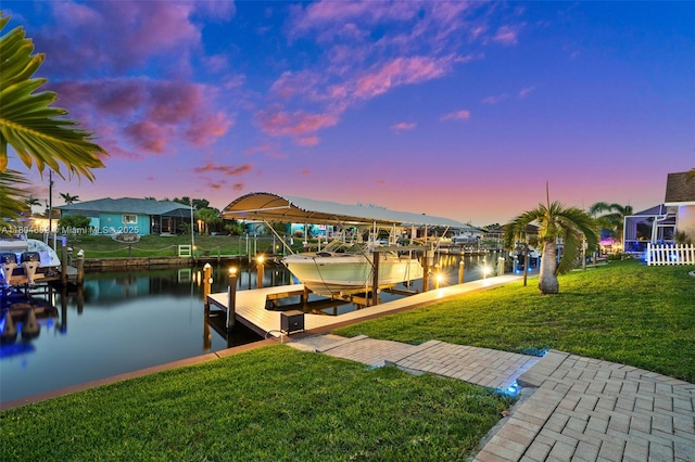 249 SW 37th Ln, Cape Coral, FL 33914 - dock with boat lift, a water view, and a lawn