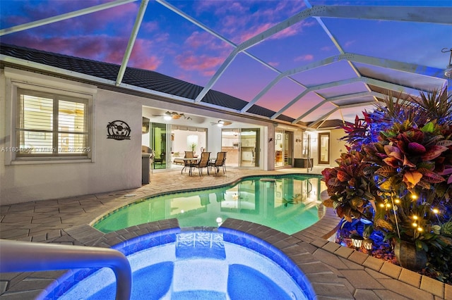 249 SW 37th Ln, Cape Coral, FL 33914 - pool at dusk with ceiling fan, a patio, a pool with connected hot tub, and a lanai