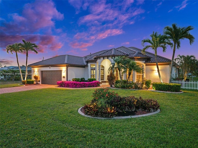 249 SW 37th Ln, Cape Coral, FL 33914 - mediterranean / spanish-style house with decorative driveway, a garage, a tiled roof, and stucco siding