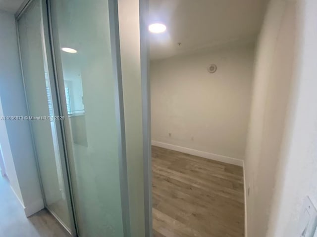 1111 SW 1st Ave Unit 2217-N, Miami, FL 33130 - hallway featuring wood finished floors and baseboards