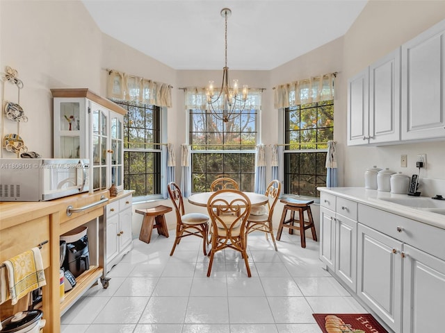 2530 E Aragon Blvd Unit 1, Sunrise, FL 33313 - dining area featuring a chandelier, healthy amount of natural light, and light tile patterned floors