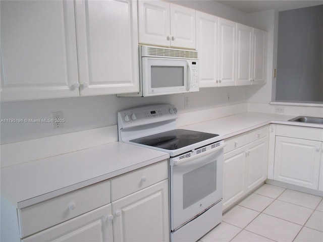 4112 Pine Ridge Ln, Weston, FL 33331 - kitchen with white appliances, white cabinetry, light countertops, and light tile patterned floors