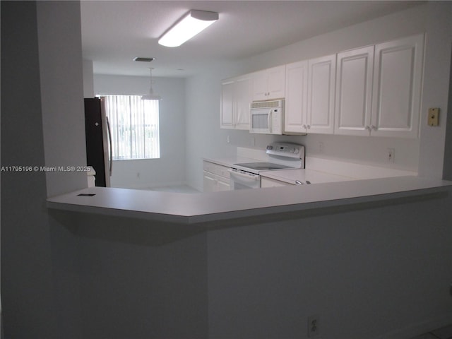 4112 Pine Ridge Ln, Weston, FL 33331 - kitchen with white appliances, white cabinets, light countertops, and a peninsula