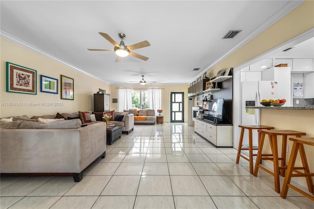 1241 Stillwater Dr, Miami Beach, FL 33141 - living area with light tile patterned floors, ornamental molding, and a ceiling fan