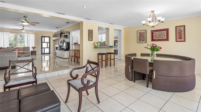 1241 Stillwater Dr, Miami Beach, FL 33141 - dining space with crown molding, a chandelier, a ceiling fan, light tile patterned flooring, and baseboards