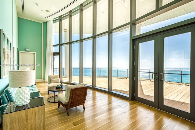 15701 Collins Ave Unit 1603, Sunny Isles Beach, FL 33160 - living area with a high ceiling, floor to ceiling windows, french doors, wood finished floors, and a water view