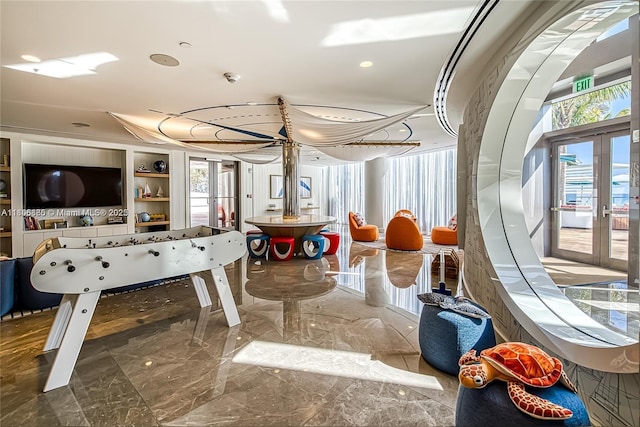 15701 Collins Ave Unit 1603, Sunny Isles Beach, FL 33160 - rec room with marble tiled flooring, french doors, recessed lighting, and built in shelves